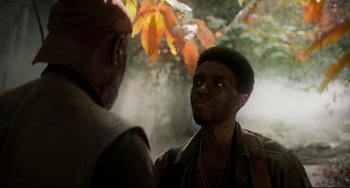 Movie still from “Da 5 Bloods” (2020), directed by Spike Lee – Two men are talking in the forest; Close Up shot, Over the shoulder angle