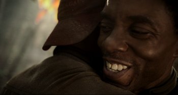 Movie still from “Da 5 Bloods” (2020), directed by Spike Lee – A person with a hat on smiling; Close Up shot, Over the shoulder angle
