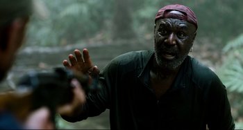 Movie still from “Da 5 Bloods” (2020), directed by Spike Lee – An older man holding a camera in the woods; Close Up shot, High angle