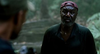 Movie still from “Da 5 Bloods” (2020), directed by Spike Lee – An older man wearing a red bandana and a black shirt; Close Up shot, Over the shoulder angle