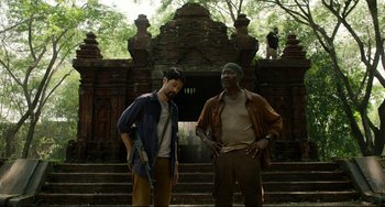 Movie still from “Da 5 Bloods” (2020), directed by Spike Lee – Two men standing next to each other in front of a building; Medium shot, Low angle
