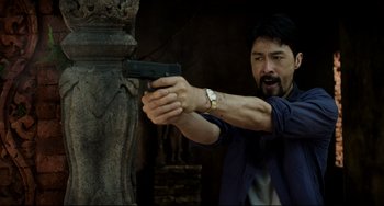 Movie still from “Da 5 Bloods” (2020), directed by Spike Lee – A man holding a gun in his hand; Medium shot, Low angle