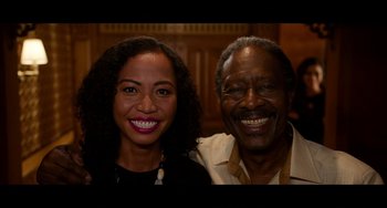 Movie still from “Da 5 Bloods” (2020), directed by Spike Lee – A woman and an older man smile for a picture; Close Up shot, High angle