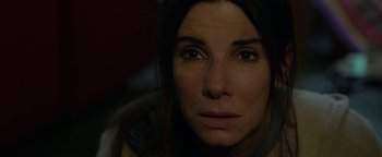 Movie still from “Bird Box” (2018), directed by Susanne Bier – A woman's face in the dark; Close Up shot, High angle