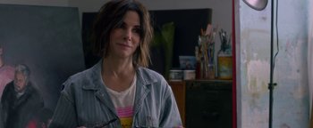 Movie still from “Bird Box” (2018), directed by Susanne Bier – A woman in a denim jacket is holding a paintbrush; Close Up shot, Over the shoulder angle