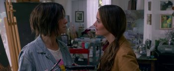 Movie still from “Bird Box” (2018), directed by Susanne Bier – Two women talking to each other in a cluttered room; Close Up shot, Over the shoulder angle