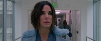 Movie still from “Bird Box” (2018), directed by Susanne Bier – A person wearing a blue coat; Close Up shot, Over the shoulder angle