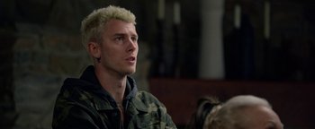 Movie still from “Bird Box” (2018), directed by Susanne Bier – A man with blonde hair sitting in front of a window; Close Up shot, Over the shoulder angle