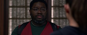 Movie still from “Bird Box” (2018), directed by Susanne Bier – A person wearing glasses and a red vest; Close Up shot, Over the shoulder angle