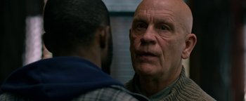 Movie still from “Bird Box” (2018), directed by Susanne Bier – An older man and a younger man are looking at one another; Close Up shot, Over the shoulder angle