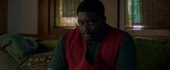 Movie still from “Bird Box” (2018), directed by Susanne Bier – A man wearing glasses and a red vest looking to his left; Close Up shot, Low angle