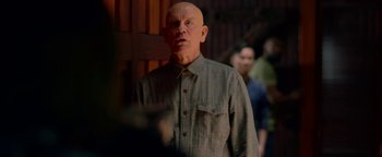 Movie still from “Bird Box” (2018), directed by Susanne Bier – An old man with a bald head and a beard; Medium shot, Over the shoulder angle