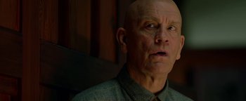 Movie still from “Bird Box” (2018), directed by Susanne Bier – A man with a bald head looking up at the sky; Close Up shot, Low angle