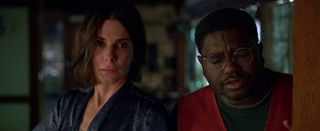 Movie still from “Bird Box” (2018), directed by Susanne Bier – A woman standing next to a man in front of a building; Close Up shot, Over the shoulder angle