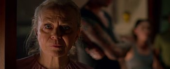 Movie still from “Bird Box” (2018), directed by Susanne Bier – An older woman looking at the camera with an intense look on her face; Close Up shot, Over the shoulder angle