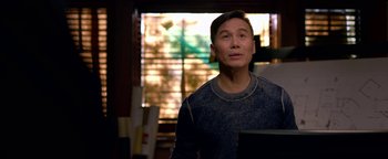 Movie still from “Bird Box” (2018), directed by Susanne Bier – A man standing in front of a window looking up; Medium shot, Over the shoulder angle