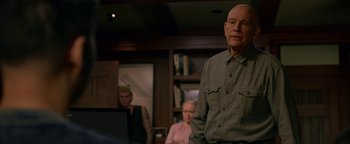 Movie still from “Bird Box” (2018), directed by Susanne Bier – An older man standing in front of an older woman; Medium shot, Over the shoulder angle