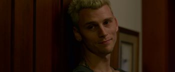 Movie still from “Bird Box” (2018), directed by Susanne Bier – A person with a blonde mohawk; Close Up shot, Over the shoulder angle