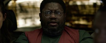 Movie still from “Bird Box” (2018), directed by Susanne Bier – A person wearing glasses and a red jacket; Close Up shot, Low angle