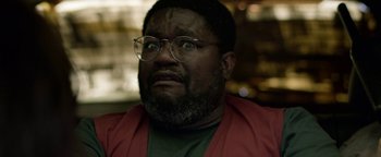 Movie still from “Bird Box” (2018), directed by Susanne Bier – A person wearing glasses and a red jacket; Close Up shot, Low angle