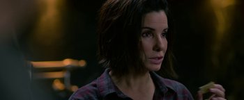 Movie still from “Bird Box” (2018), directed by Susanne Bier – A person wearing a plaid shirt; Close Up shot, Over the shoulder angle