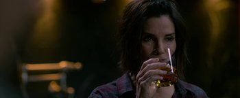 Movie still from “Bird Box” (2018), directed by Susanne Bier – A woman holding a glass of beer in her hand; Close Up shot, High angle