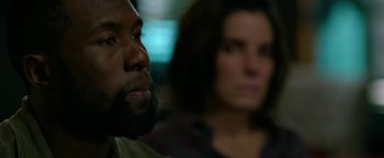 Movie still from “Bird Box” (2018), directed by Susanne Bier – A man and a woman sitting next to each other; Close Up shot, Over the shoulder angle