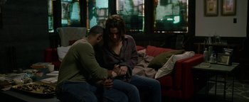 Movie still from “Bird Box” (2018), directed by Susanne Bier – A man and a woman sitting on a couch; Medium shot, High angle