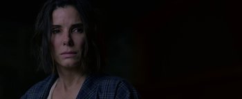 Movie still from “Bird Box” (2018), directed by Susanne Bier – A person wearing a plaid shirt; Close Up shot, Over the shoulder angle