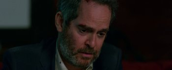 Movie still from “Bird Box” (2018), directed by Susanne Bier – A person wearing a suit and tie; Close Up shot, Over the shoulder angle