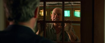 Movie still from “Bird Box” (2018), directed by Susanne Bier – An older man looking at himself in a mirror; Close Up shot, Over the shoulder angle