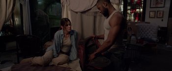 Movie still from “Bird Box” (2018), directed by Susanne Bier – A man and a woman looking into a backpack; Medium shot, Over the shoulder angle