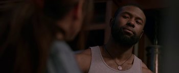 Movie still from “Bird Box” (2018), directed by Susanne Bier – A man with a beard is talking to a woman; Close Up shot, Over the shoulder angle