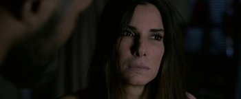 Movie still from “Bird Box” (2018), directed by Susanne Bier – A person with long dark hair; Close Up shot, High angle