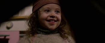 Movie still from “Bird Box” (2018), directed by Susanne Bier – A young child smiling for the camera; Close Up shot, High angle