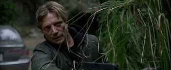 Movie still from “Bird Box” (2018), directed by Susanne Bier – A man in a black jacket is looking at the camera; Close Up shot, Over the shoulder angle