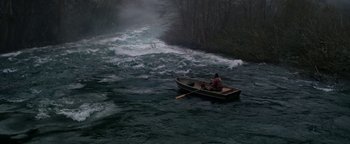 Movie still from “Bird Box” (2018), directed by Susanne Bier – A man is in a boat in the middle of a river; Extreme Wide shot, High angle