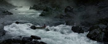 Movie still from “Bird Box” (2018), directed by Susanne Bier – A man in a canoe in the middle of a rushing river; Extreme Wide shot, High angle