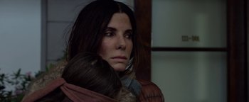Movie still from “Bird Box” (2018), directed by Susanne Bier – A woman holding a child in her arms; Close Up shot, High angle