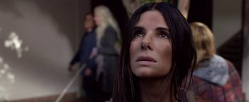 Movie still from “Bird Box” (2018), directed by Susanne Bier – A person with long black hair; Close Up shot, Low angle