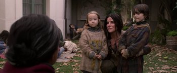 Movie still from “Bird Box” (2018), directed by Susanne Bier – A woman and a child are standing in the grass; Medium shot, High angle
