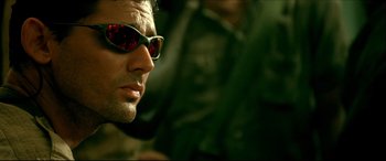 Movie still from “Black Hawk Down” (2001), directed by Ridley Scott – A person wearing sunglasses; Close Up shot, Low angle