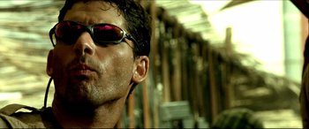 Movie still from “Black Hawk Down” (2001), directed by Ridley Scott – A man wearing sunglasses; Close Up shot, Low angle