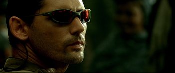 Movie still from “Black Hawk Down” (2001), directed by Ridley Scott – A person wearing sunglasses; Close Up shot, Low angle