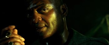 Movie still from “Black Hawk Down” (2001), directed by Ridley Scott – A person's face in the dark; Close Up shot, Low angle