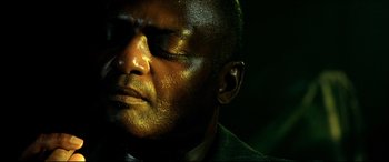 Movie still from “Black Hawk Down” (2001), directed by Ridley Scott – A person with his eyes closed; Close Up shot, High angle