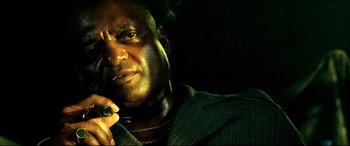 Movie still from “Black Hawk Down” (2001), directed by Ridley Scott – A person wearing a suit and tie; Close Up shot, Low angle