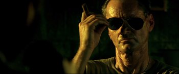 Movie still from “Black Hawk Down” (2001), directed by Ridley Scott – A person holding a cell phone; Close Up shot, Low angle