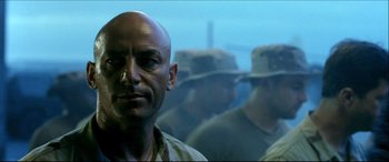 Movie still from “Black Hawk Down” (2001), directed by Ridley Scott – A person in a military uniform; Close Up shot, Low angle