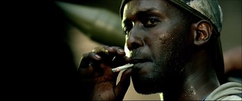 Movie still from “Black Hawk Down” (2001), directed by Ridley Scott – A person smoking a cigarette; Close Up shot, Low angle